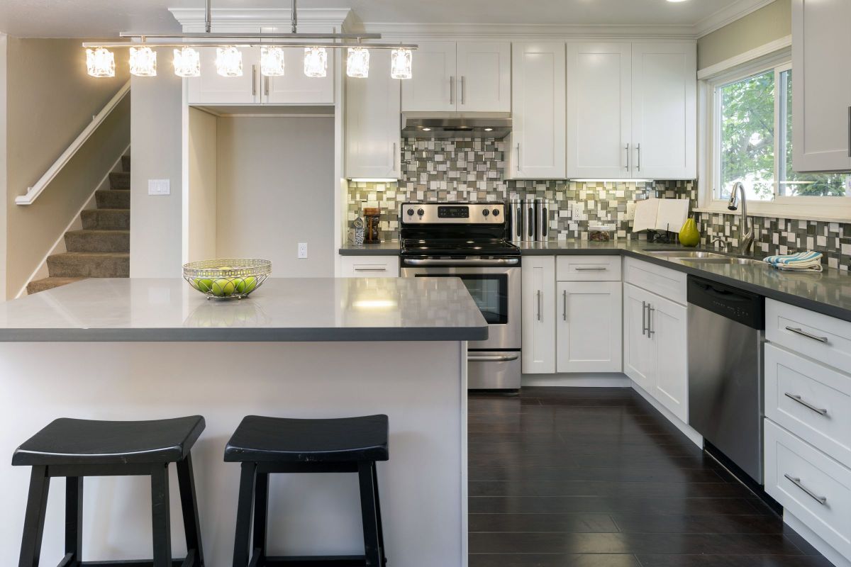 White and Black Custom Kitchen Countertops with Bar Stool Seating and Cabinets