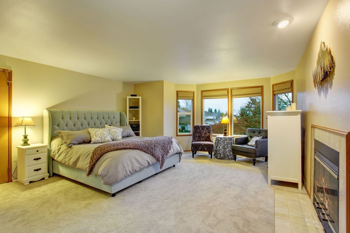 Yellow Bedroom with Fireplace Mantle