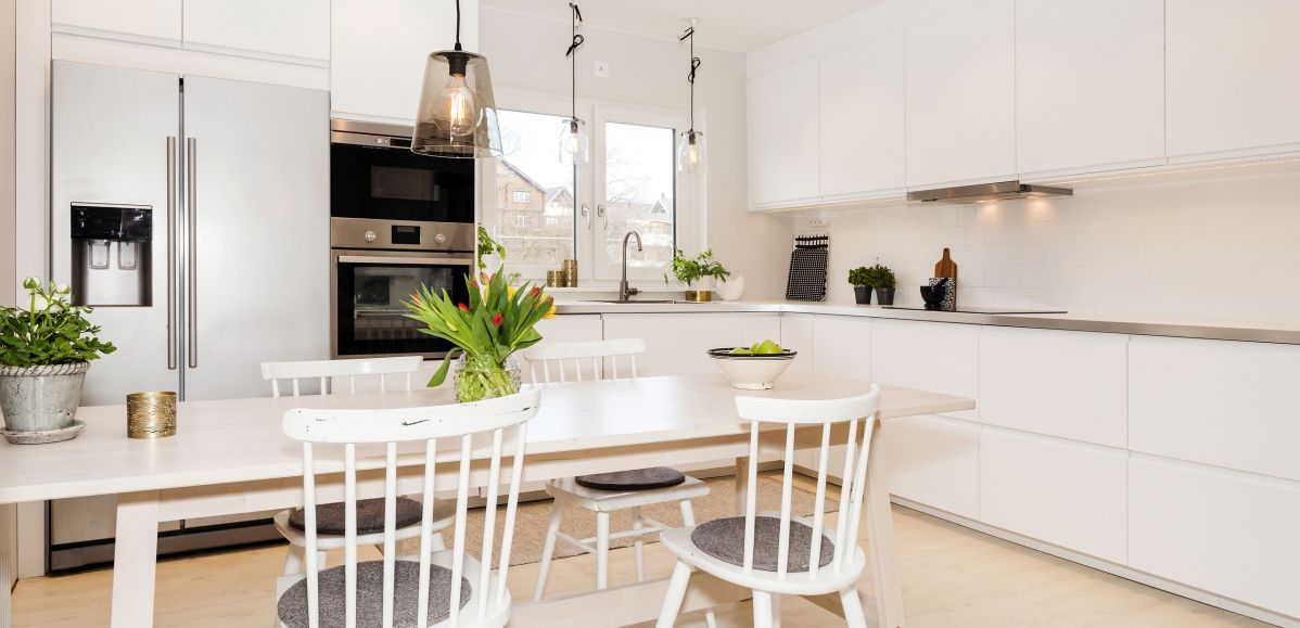 Incredibly Gleaming White Contrasting Kitchen Cabinets, Appliances, and Countertops