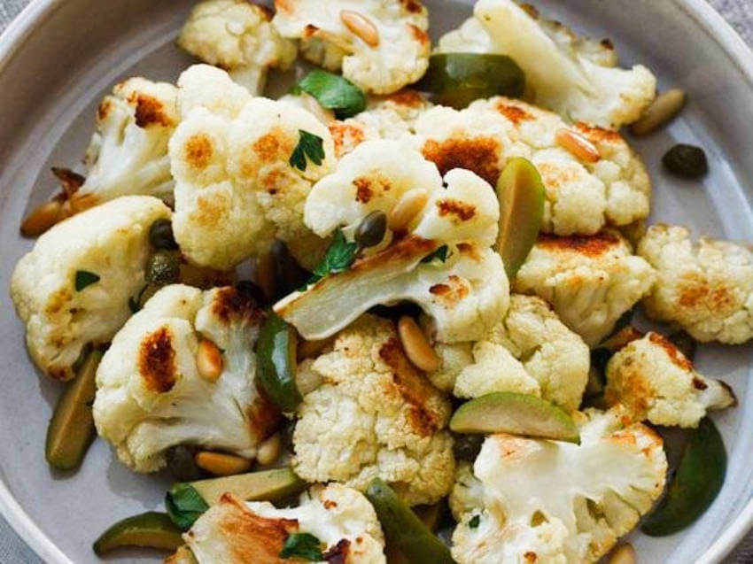 Roasted cauliflower with olives and pine nuts is a perfect sweet and salty balance!